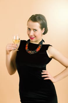 Studio portrait of a beautiful young brunette woman holding a glass of white wine