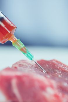 Food scientist injecting raw meat at the university