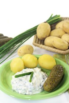 Herb curd with boiled potatoes and pickled cucumber