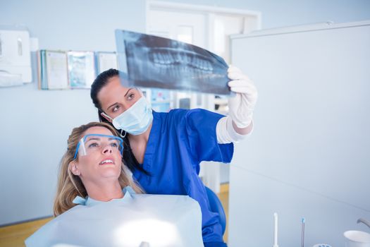 Dentist explaining x-ray to patient at the dental clinic