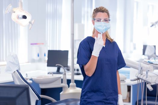 Dentist in mask and glove holding an injection at the dental clinic