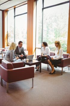 Business people talking and working together on sofa in the office