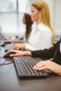 Close up of a businesswoman typing on keyboard in the office