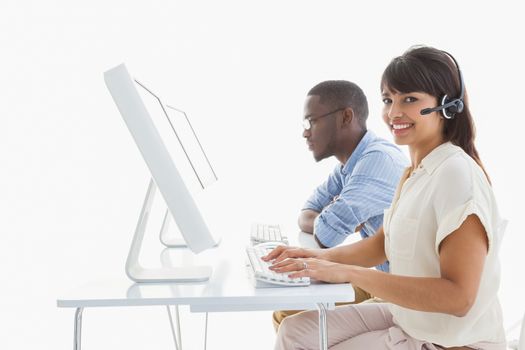 Smiling teamwork using computer and headset in the office