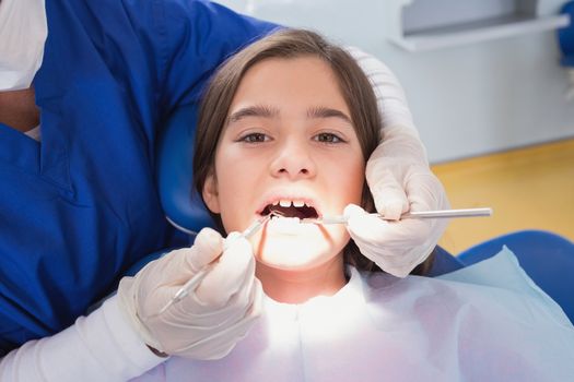 Scared young patient in dental examination in clinic