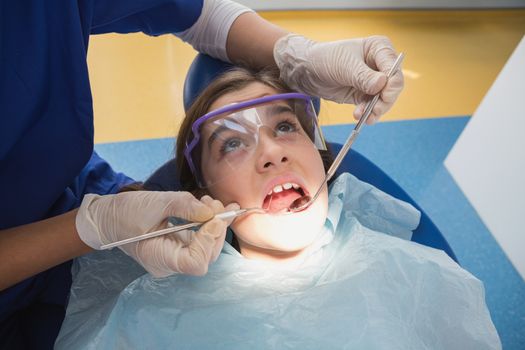 Young patient wearing safety glasses during the examination in dental clinic