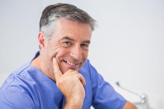 Portrait of a cheerful dentist in dental clinic