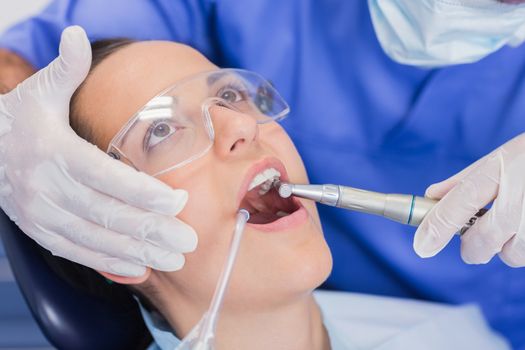 Dentist examining a patient with tools in dental clinic