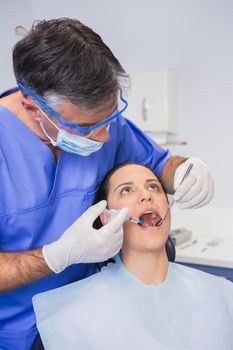 Dentist doing injection to his patient in dental clinic