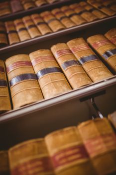 Close up of shelf with old books in library