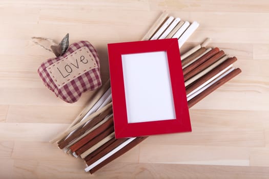 Beautiful composition with photo frames and wooden sticks.