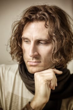 An image of a young man with curly hair
