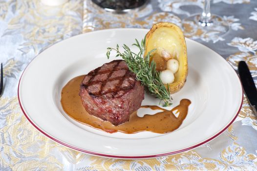 grilled beef steak with herbs and vegetables