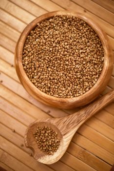 buckwheat at wooden plate on wooden background
