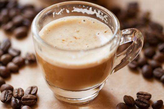 Cup of latte coffee with a biscotti