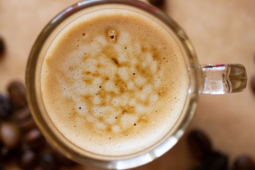 Cup of latte coffee with a biscotti