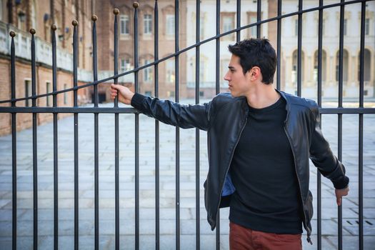 Handsome young man outside historical building in European city (Venaria Reale, near Turin, Italy)