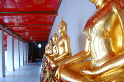 Gold buddha statues at thai monastery, Bangkok, Thailand