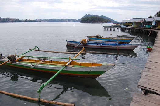 Traditional fishing boats at timber pier Indonesia, Jayapura