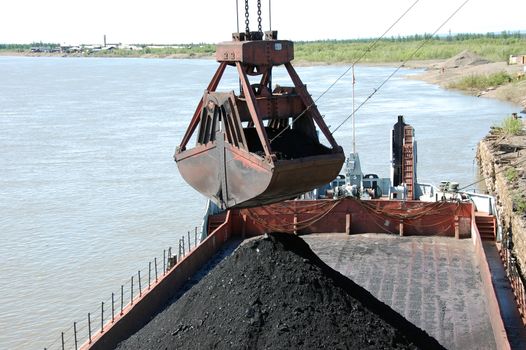 Slackline cableway bucket with coal at river port, Russia