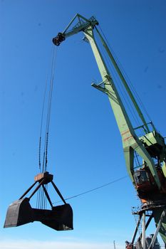 Dockside cargo crane with opened bucket, Russia