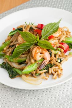 Thai food shrimp stir fry with lo mein noodles Shallow depth of field.