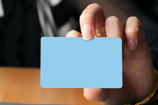 Female hand holding a blank business card gift card or credit card.  Plenty of copyspace for your logo or design.