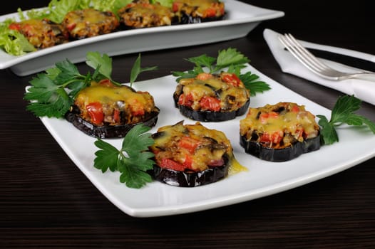 Warm appetizer of eggplant stuffed with vegetables and cheese