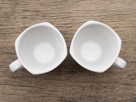 Two blank white teacup on wood