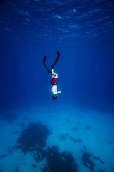 Underwater image of a Freediver with fins going down