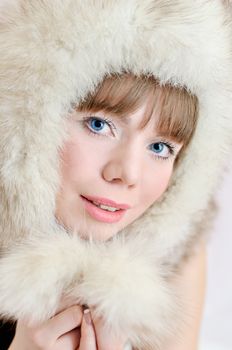 Beautiful tender smiling woman wearing fur hat 