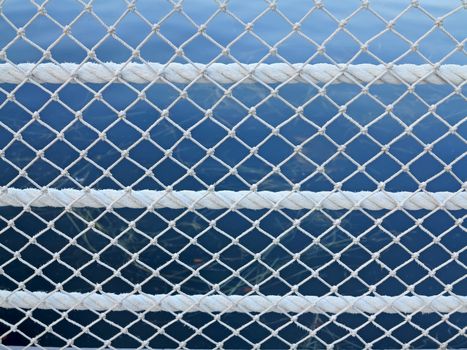 Rope and Net pattern with a lake behind