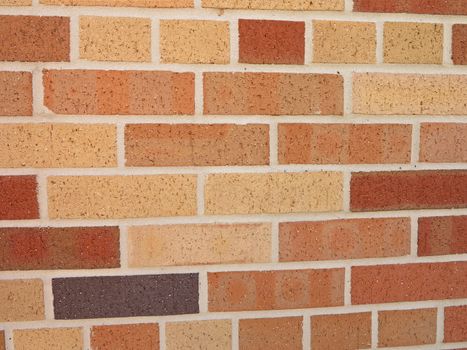 A brick wall with different color bricks