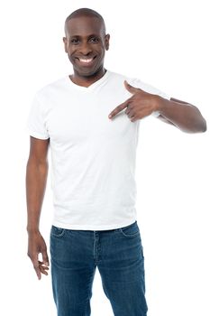 Middle aged man pointing his fingers on a blank t-shirt