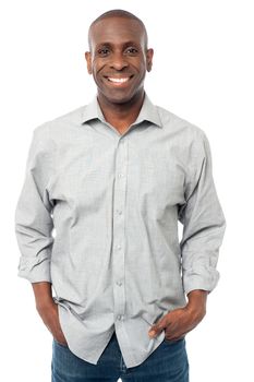 Young man standing with hands in pockets