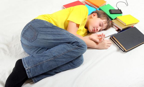 Tired Kid sleep with the Books on the Bed