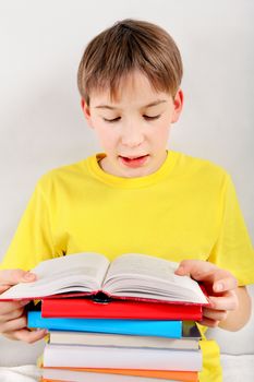 Kid read the Book at the Home on the White Wall Background