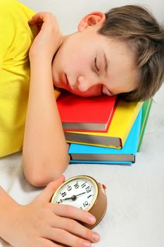 Kid sleep with Alarm Clock on the Bed