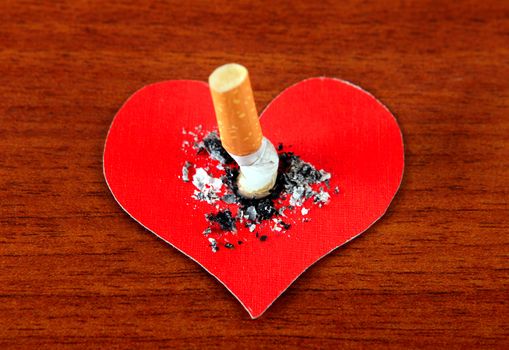 Cigarette in the Heart Shape on the Table closeup