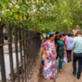 Blurred background of people walk in the street