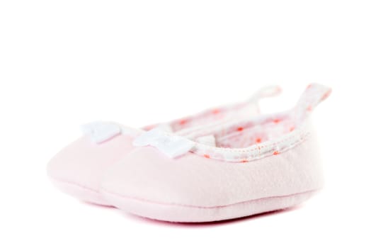 Close up pink baby shoes isolated on white background