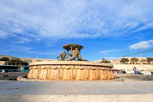 VALLETTA, MALTA - APRIL 13: The Triton Fountain in the City Gate Square of Valletta, Malta on April 13, 2014. he fountain was sculpted by local sculptor Vincent Apap in 1959