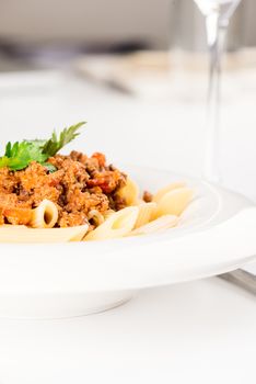 Pasta. Penne Pasta with Bolognese Sauce, Parmesan Cheese and Basil, Fork. Italian Cuisine. Mediterranean food