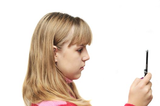 teenage girl typing sms on the mobile phone over the white 