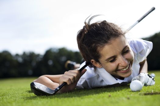 Girl playing golf on grass in summer