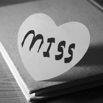 black and white paper heart write miss word