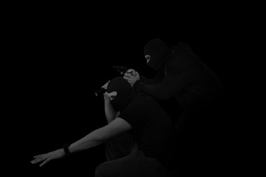 Two masked man with gun and flashlight isolated on black background. Dangerous criminal committing crime.