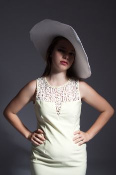 young lady in dress with white hat