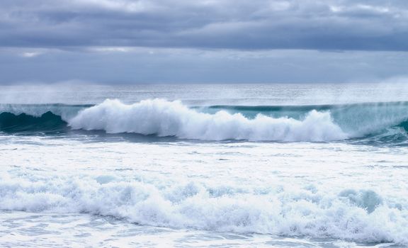 Powerful Splashing Waves on Dramatic Skies background Outdoors on Mediterranean Shore, Spain