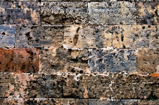 Multi-Colored Old Stone Block Wall Background closeup Outdoors